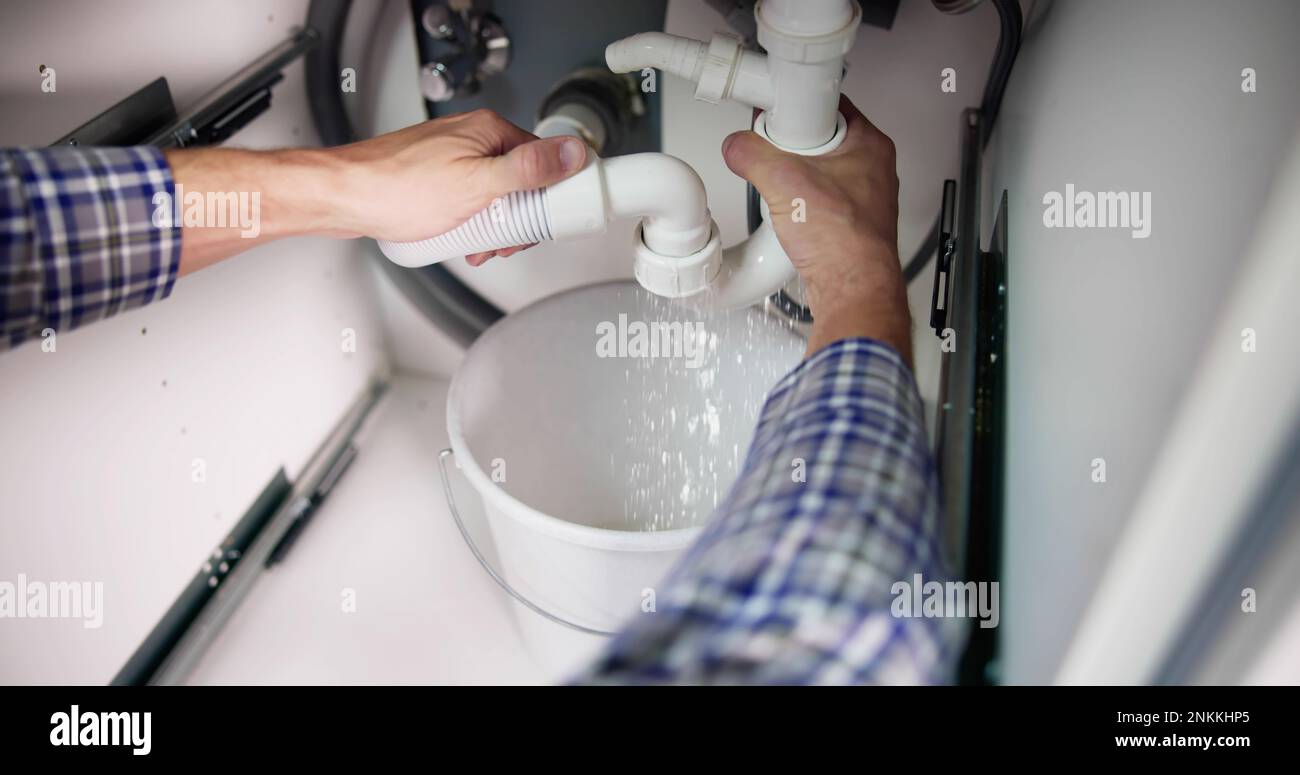 Plumber Fixing Pipe Leak. Broken Kitchen Sink Stock Photo Alamy
