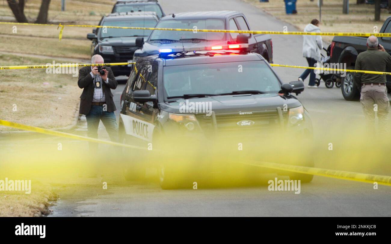 Investigators examine the scene of a shooting on Tuesday, March 8, 2022