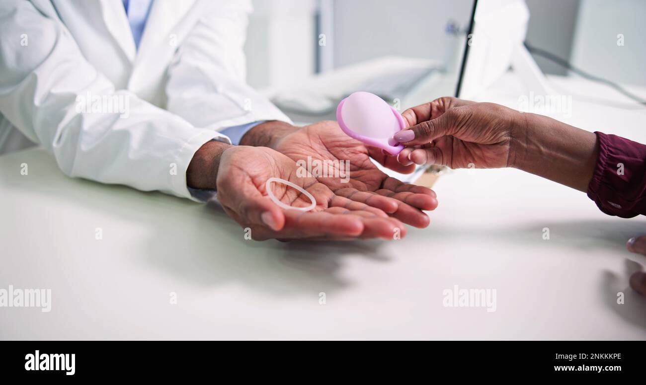 Gynecologist Consulting Woman On Diaphragm Contraception And Birth