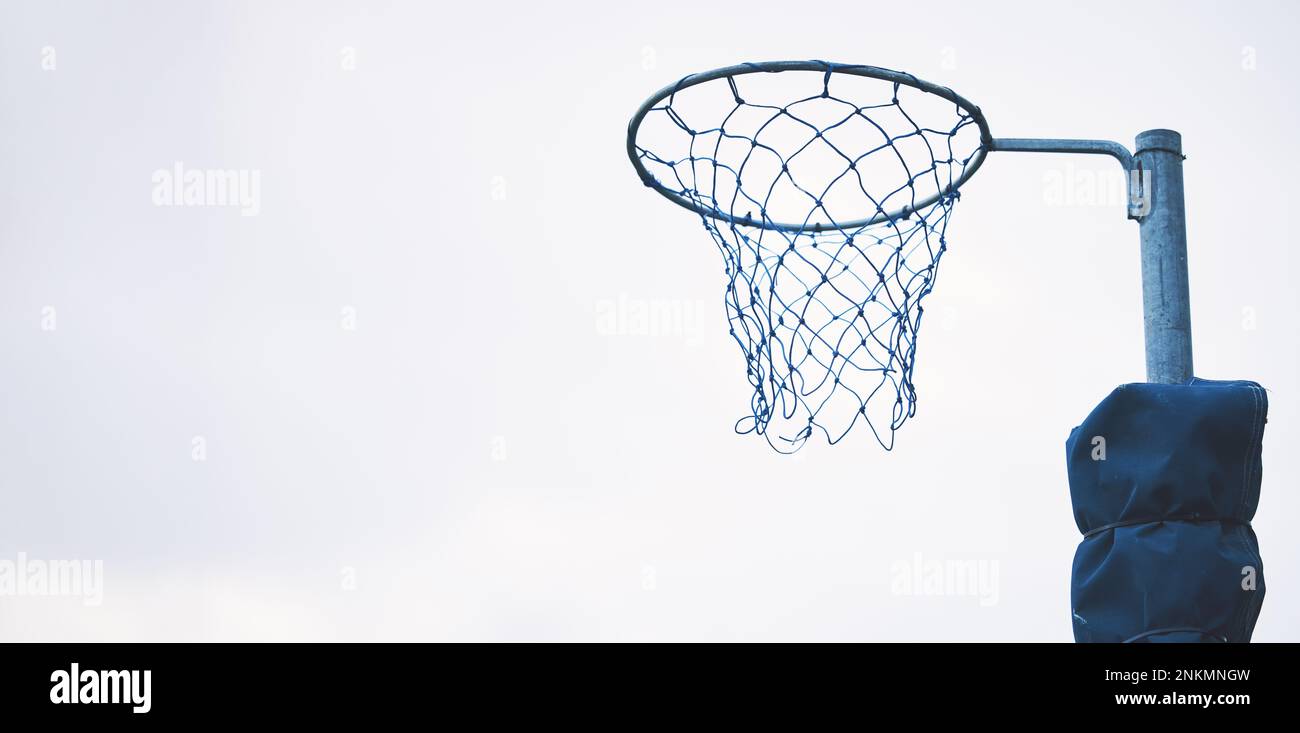 Sports, basketball and netball hoop in a park for fitness and a game at school or in public. Mockup, space and equipment for a sport in the air for Stock Photo