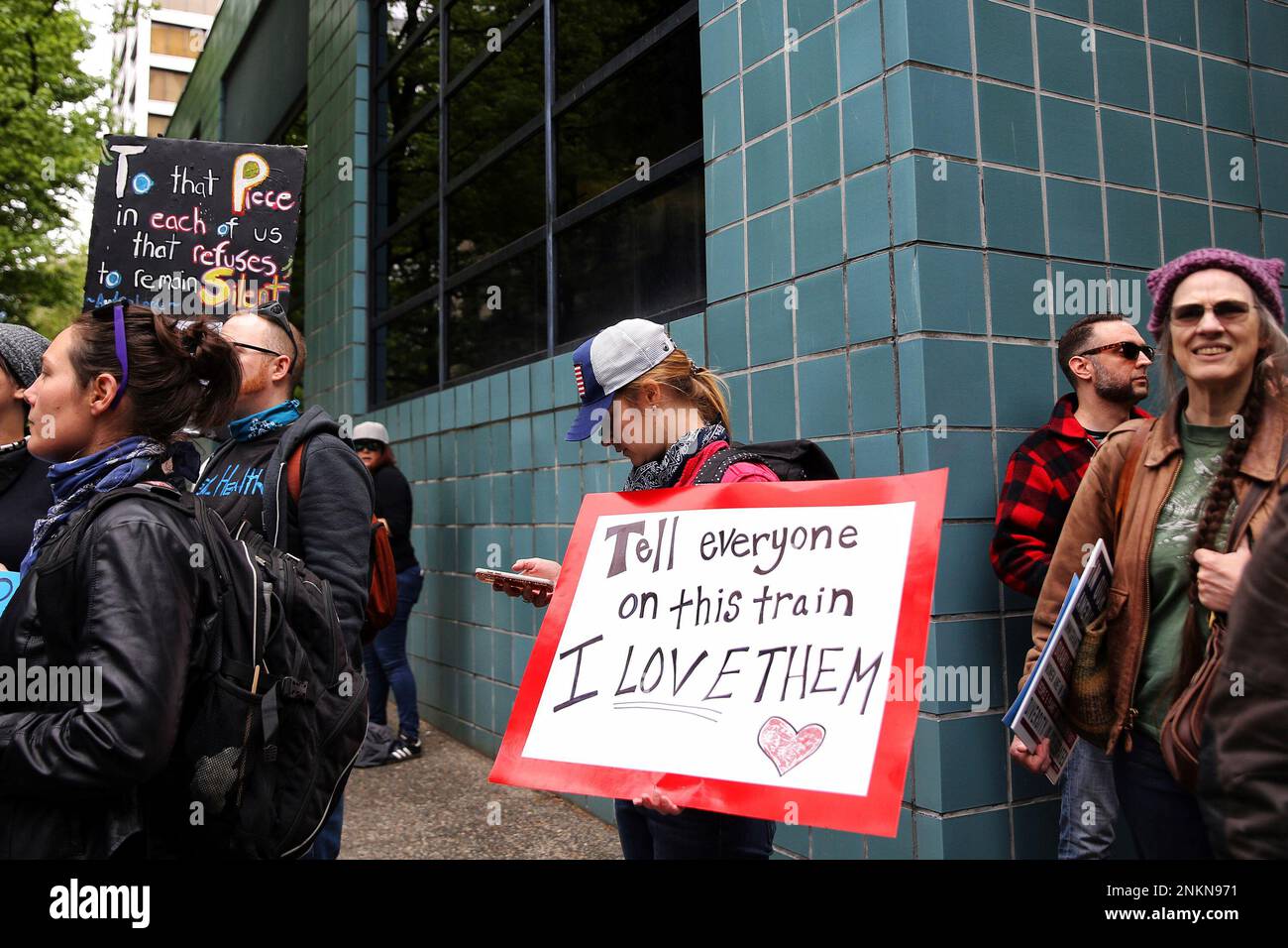Emma Sohriakoff holds a sign with the last words of Taliesin Myrddin