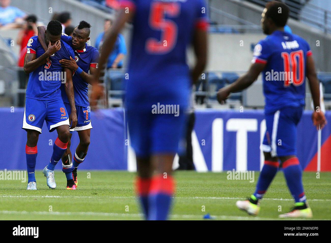 Haiti's Kervens Belfort (9) is consoled by teammate Wilde-Donald