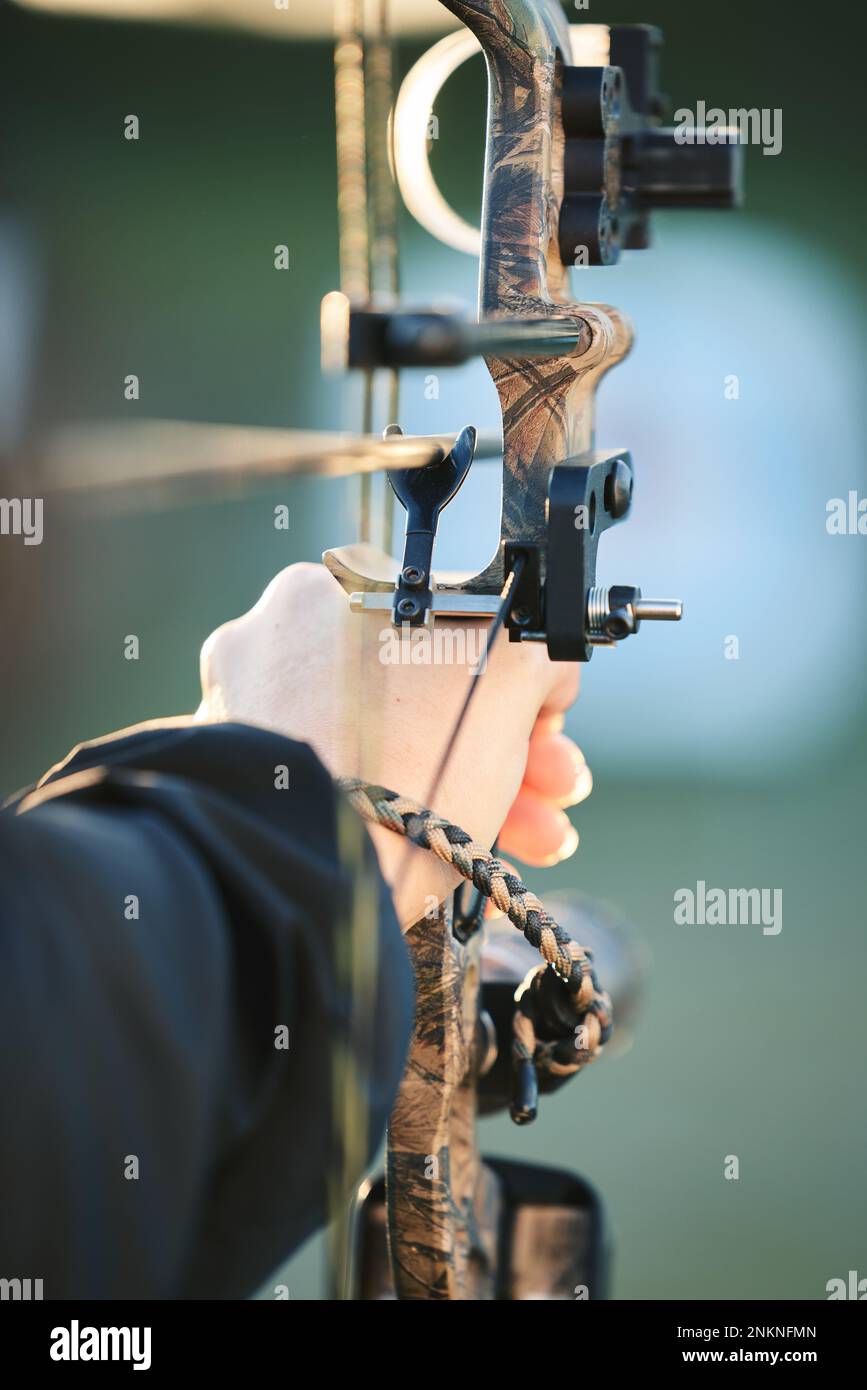 Sports archer, hands and bow and arrow training for archery competition