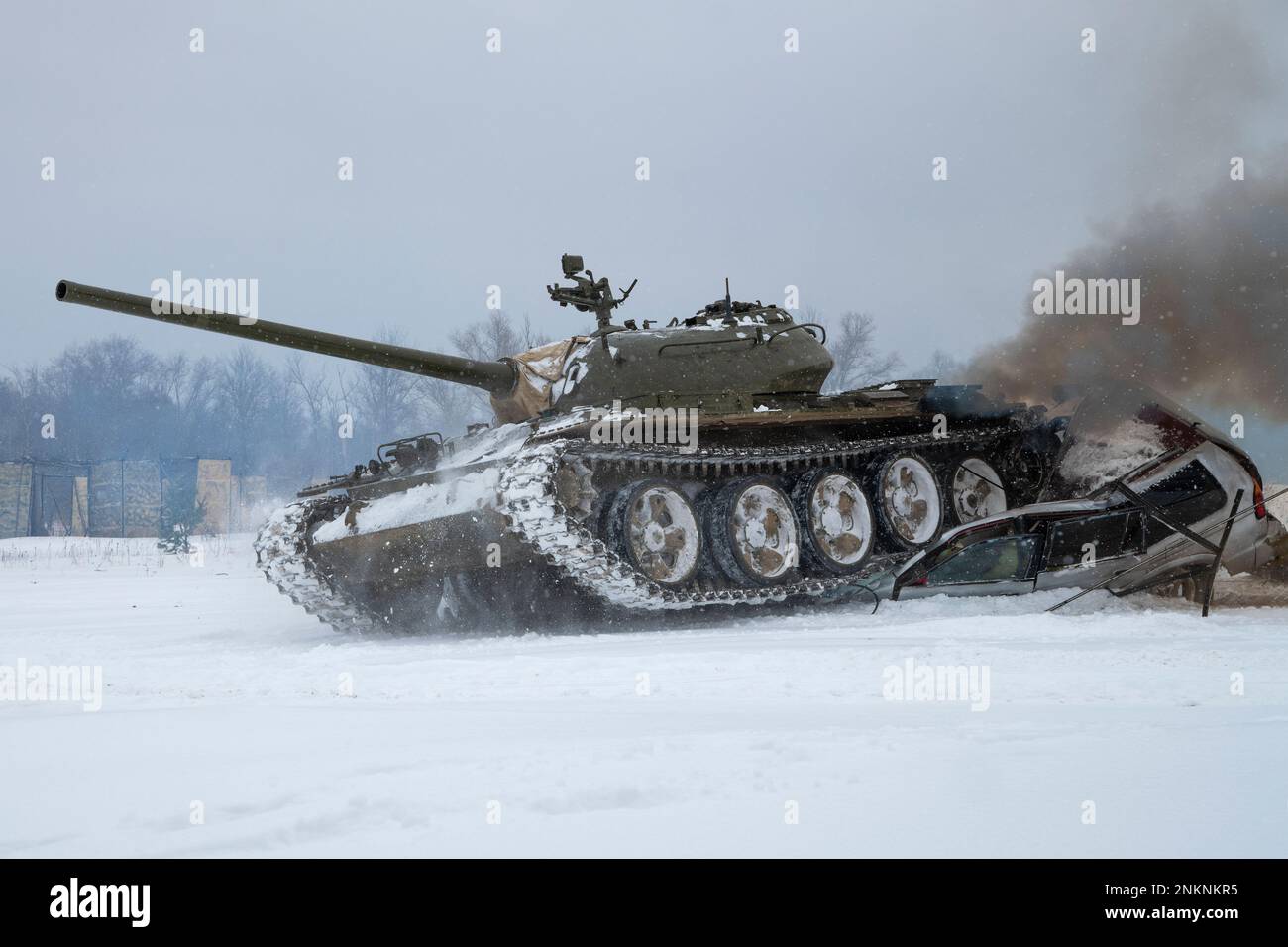 KRASNOYE SELO, RUSSIA - FEBRUARY 19, 2023: A Soviet tank T-54 crushed a passenger car. Fragment of a tank show in the military historical park 'Steel Stock Photo
