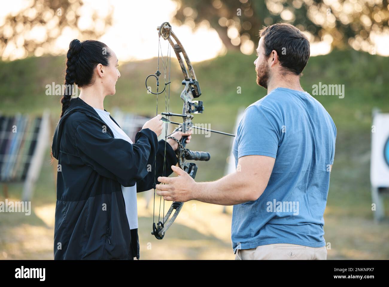 Target, training and archery woman with an instructor on field for hobby,  aim and control. Arrow, practice and archer people together outdoor for  Stock Photo - Alamy