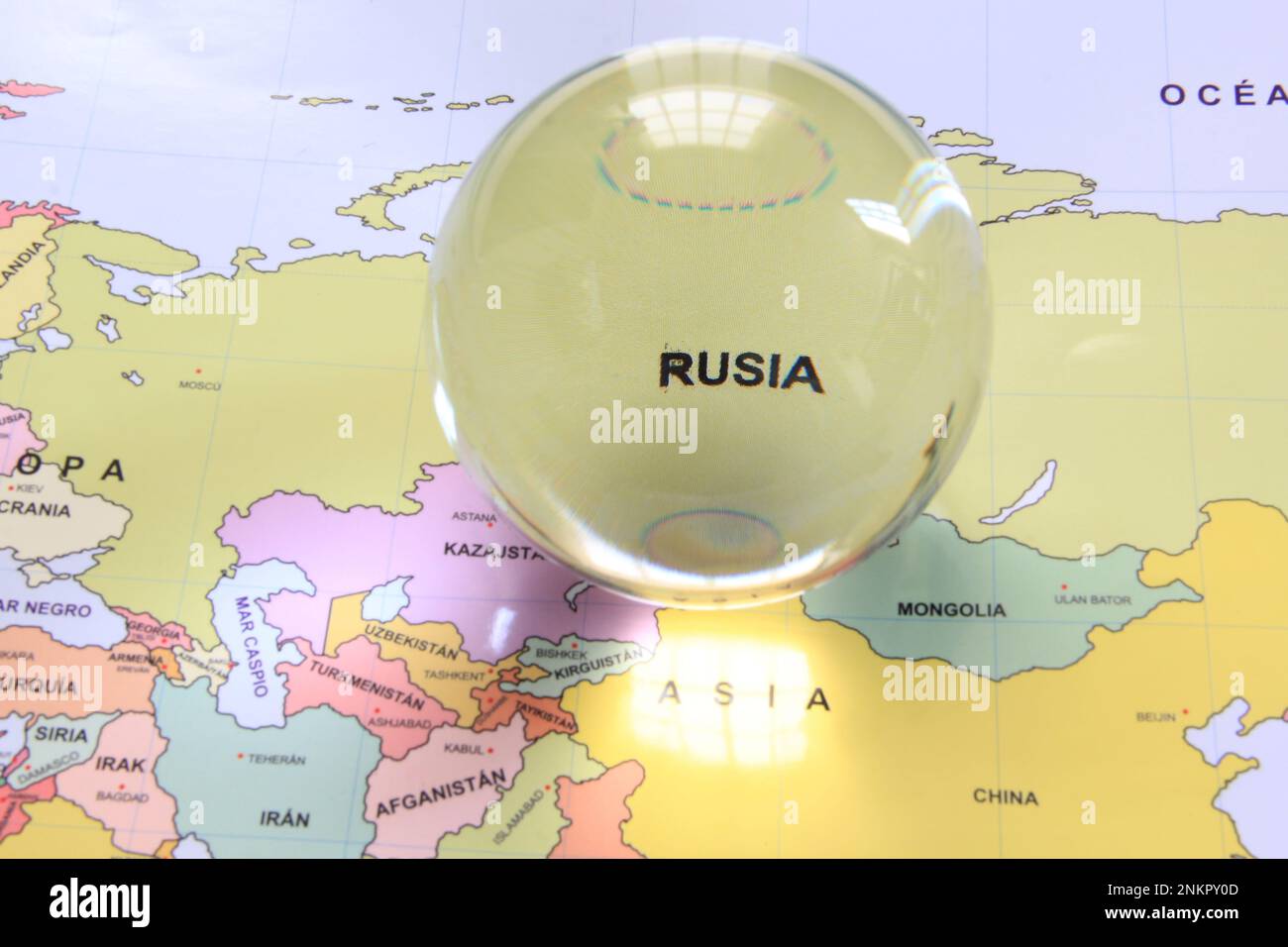 Crystal ball on a world map that highlights a country to highlight it as a magnifying glass and note its economic and financial importance: Rusia Stock Photo