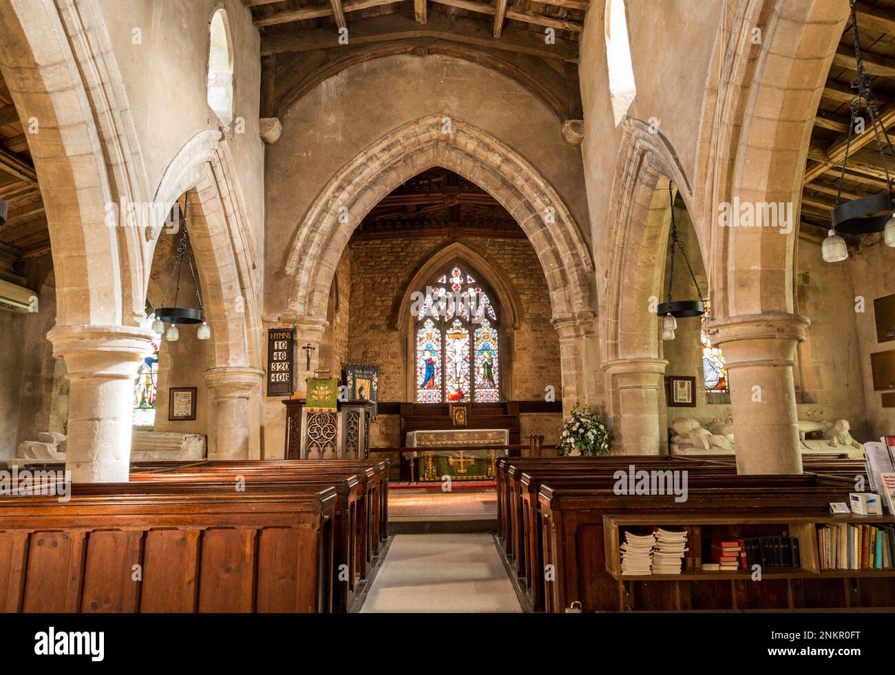 The central aisle / nave, pews and altar of the small parish church of St Mary the Virgin, Burrough on the Hill Leicestershire, England, UK Stock Photo