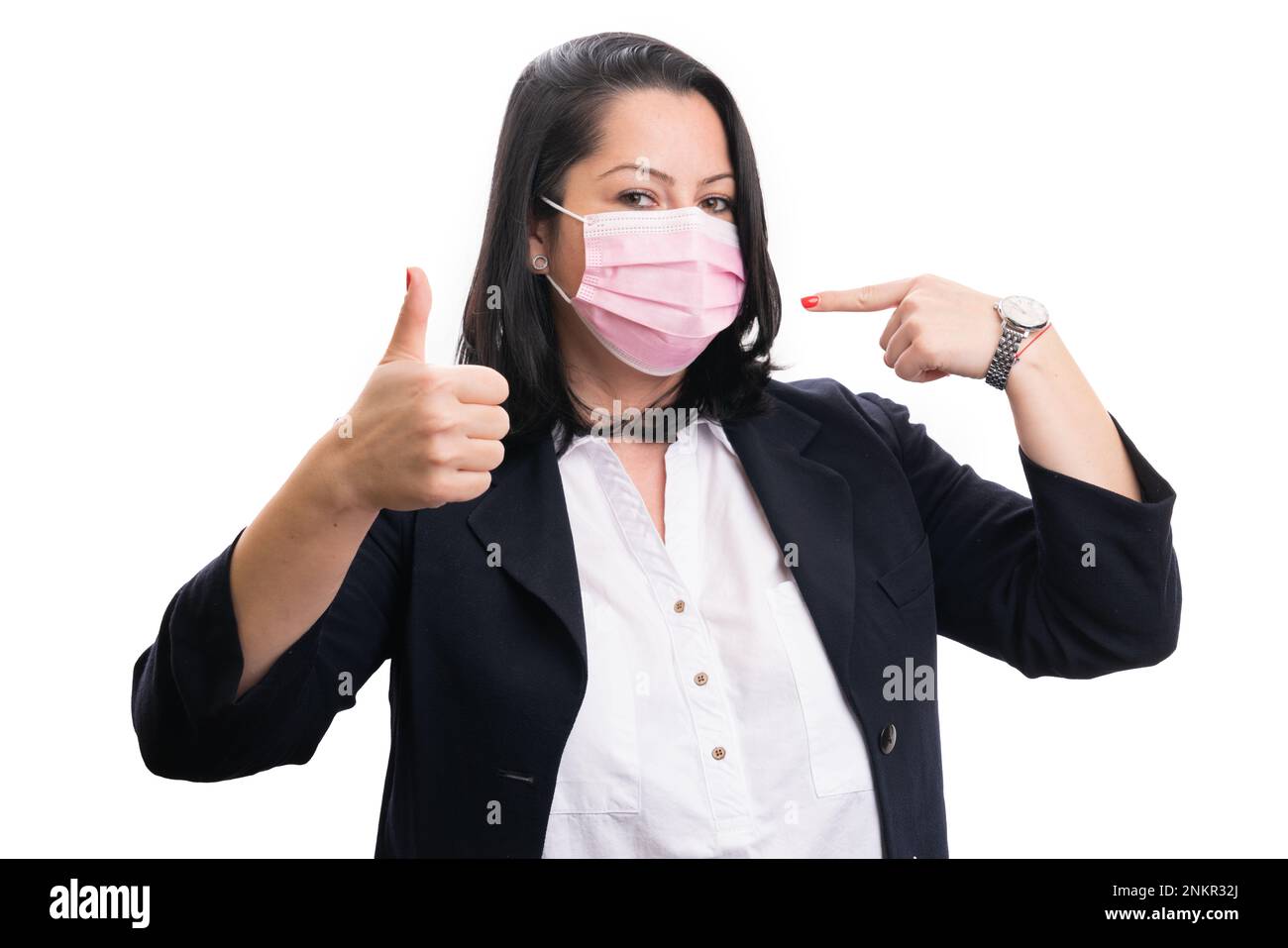 Female entrepreneur pointing index finger at pink disposable protective ...