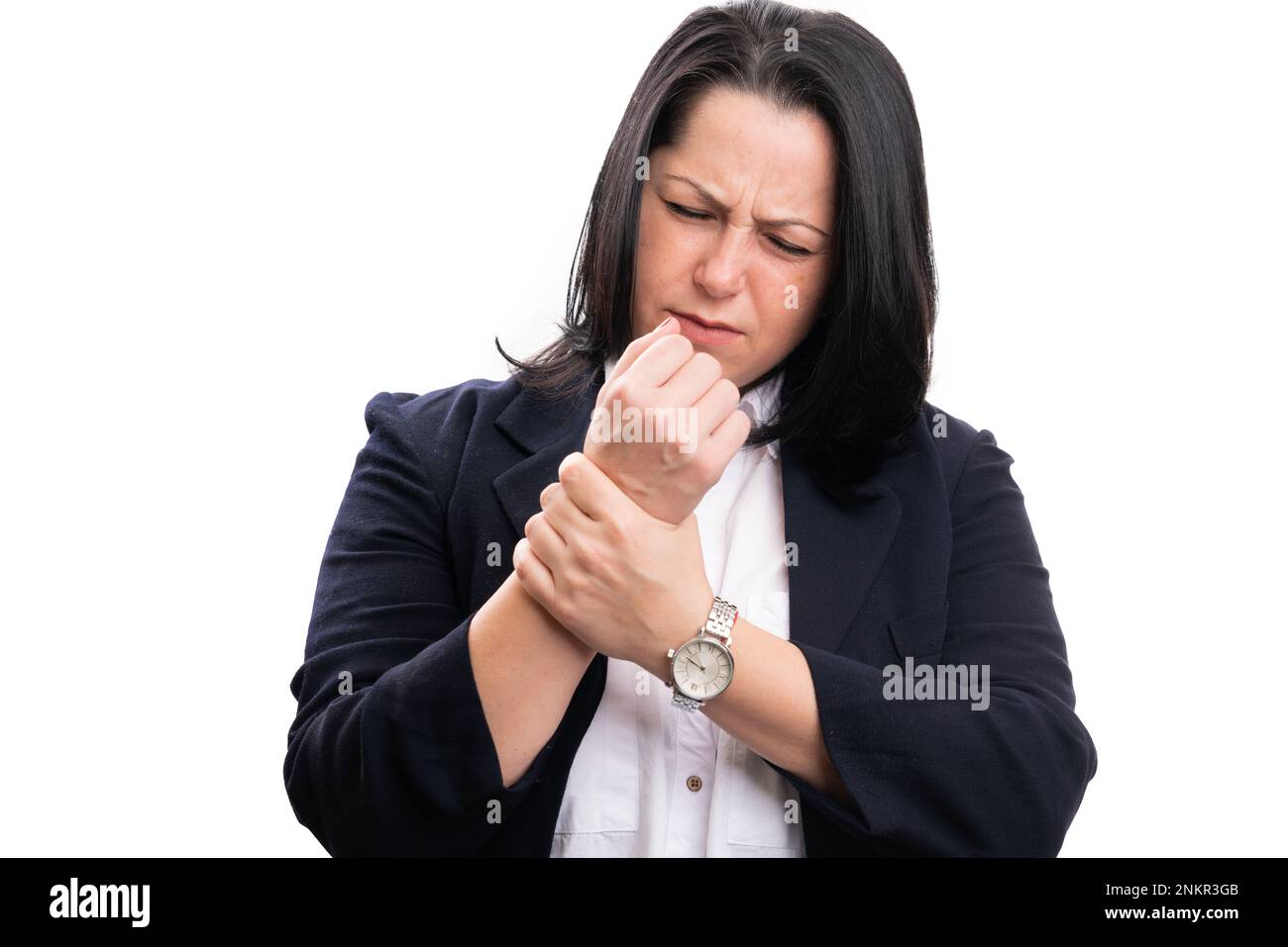 Adult businesswoman with hurting expression in formalwear touching painful sprained wrist articulation isolate on white studio background Stock Photo