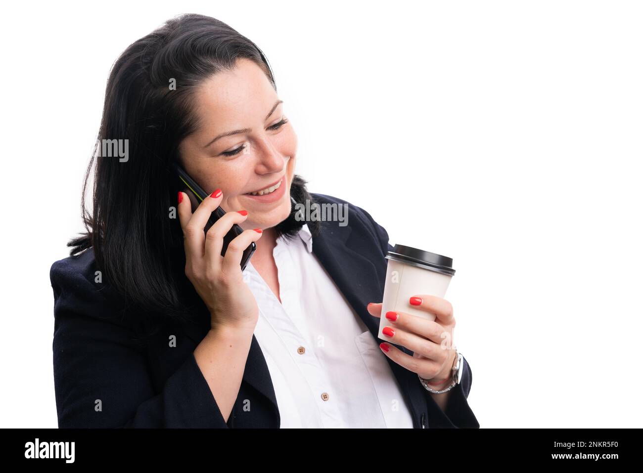 Adult businesswoman in office clothing smiling making phonecall holding take away cup of coffee isolated on white background Stock Photo