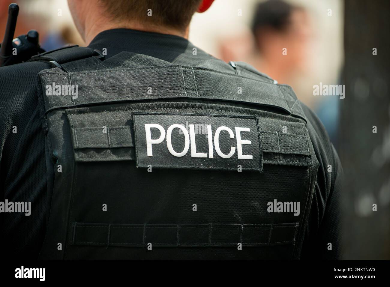 Whitehall, London, UK. 16th July 2016. Police logo patch, being worn on the rear of a bullet proof vest by a Metropolitan police officer in London. Stock Photo