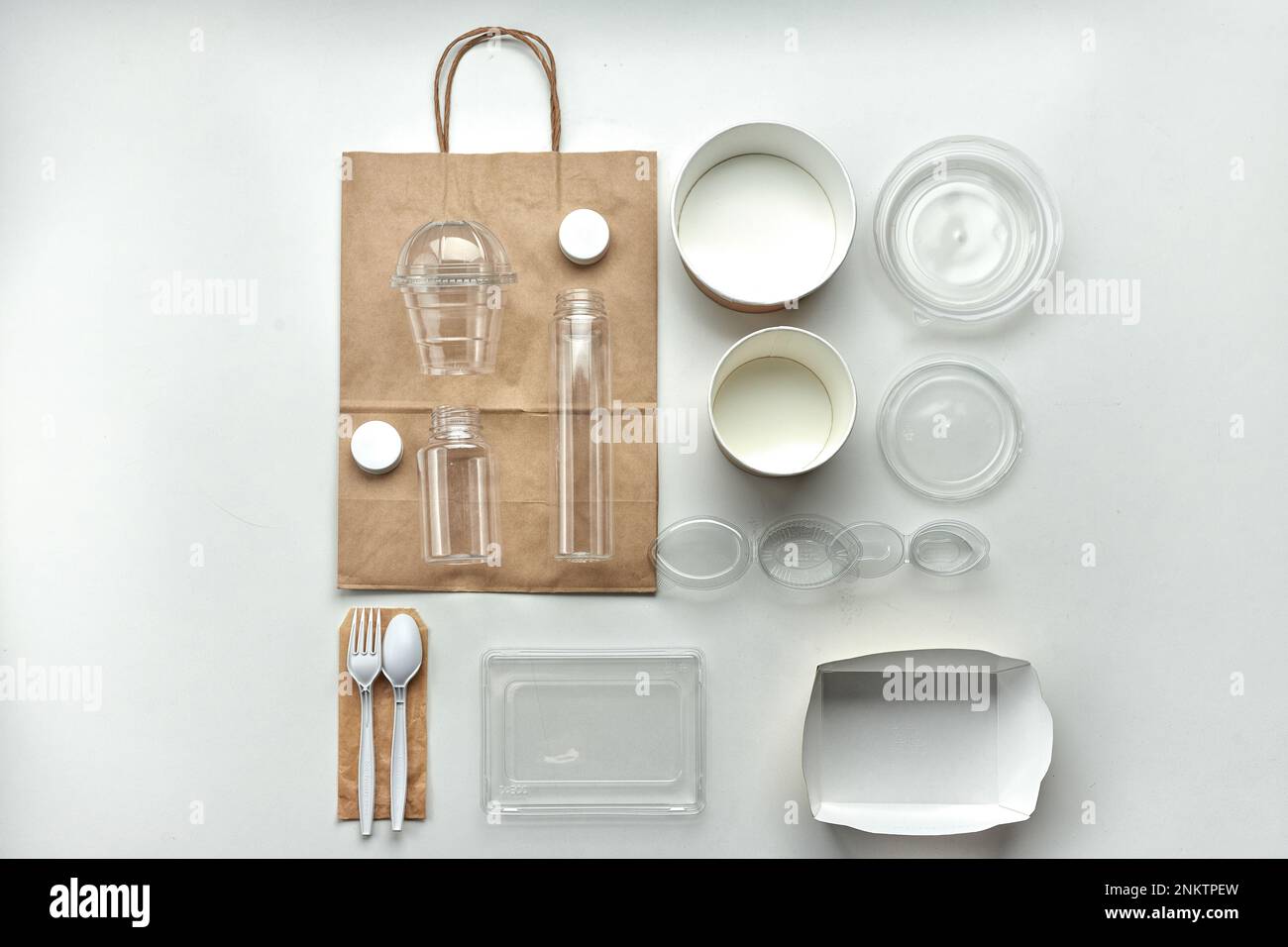Various disposable tableware bottles and containers on a white background. Horizontal Stock Photo