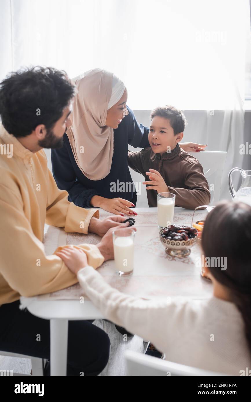 Muslim family talking during traditional suhur breakfast at home,stock image Stock Photo
