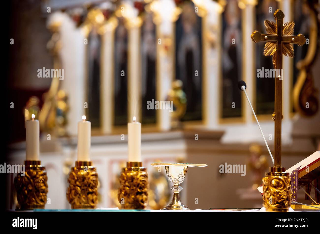 interiors and details in catholic church view of the altar, candles and