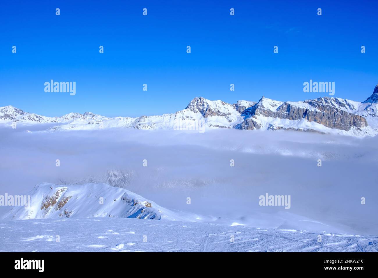 Over a cloud carpet with snow covered Swiss Alps in Viamala, Valferrera, Switzerland Stock Photo