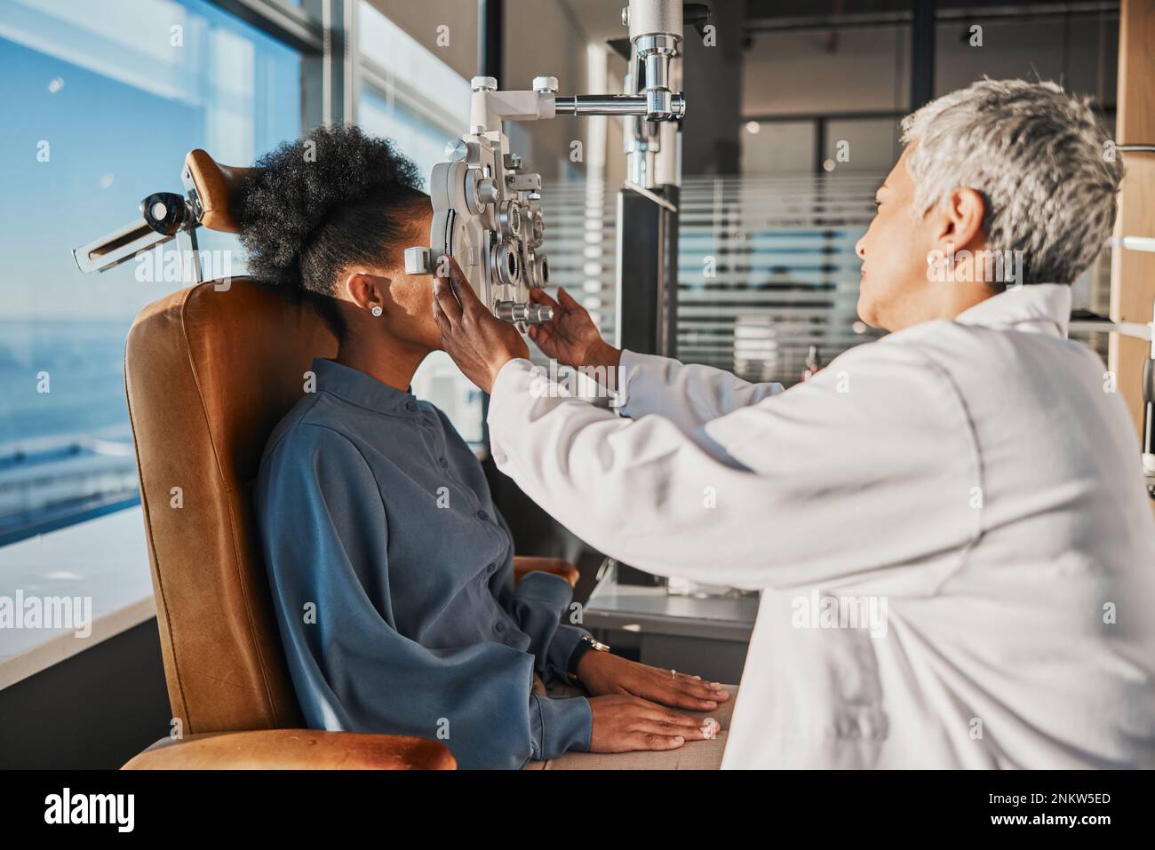 Vision test, eye exam and black woman with optometrist for testing