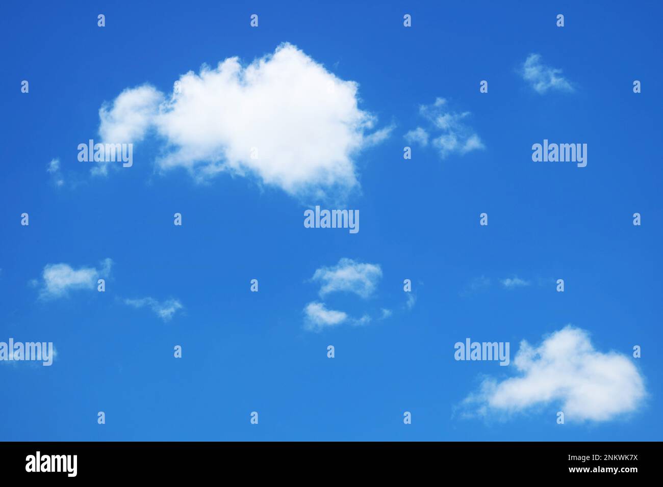 Fluffy Pure White Clouds Floating on Vivid Blue Sky Stock Photo