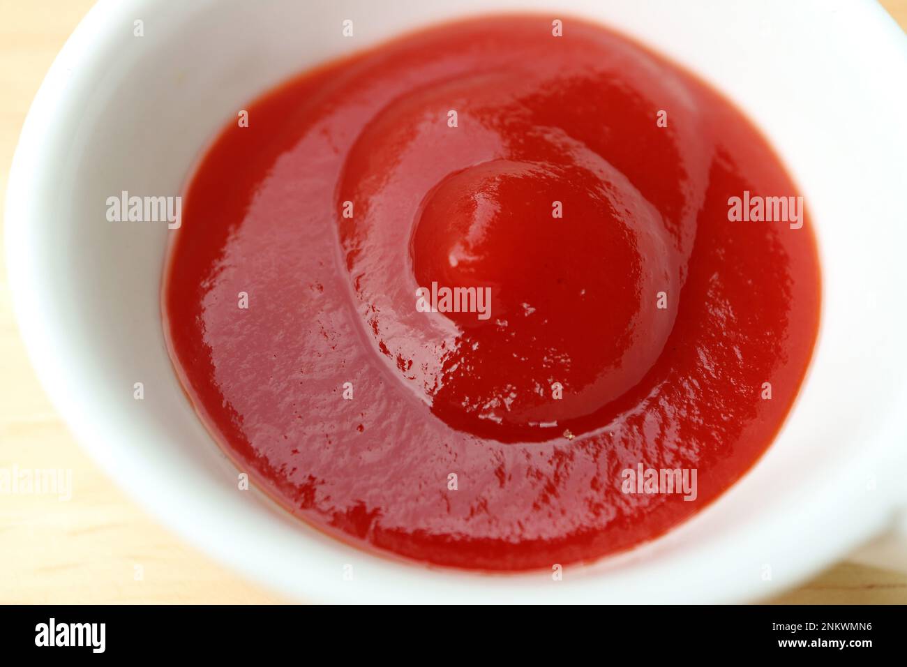 Closeup of Tomato Ketchup in a White Bowl Stock Photo