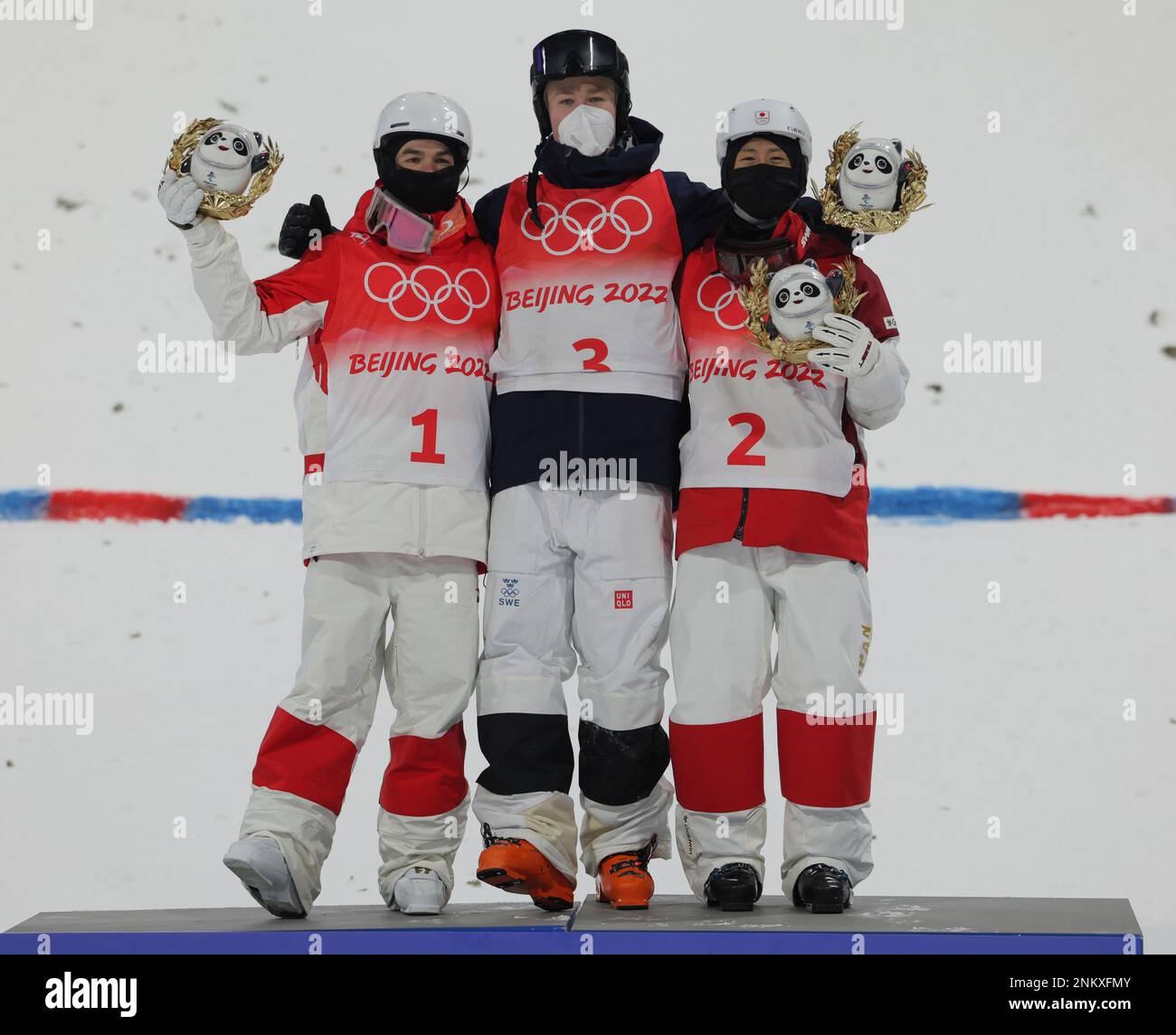 L-R) Mikael Kingsbury od Canada, silver, Walter WALLBERG of Sweden, gold,  and Ikuma Horishima of Japan, bronze, celebrate during the flower ceremony  of the Men's Moguls Final at Genting Snow Park A