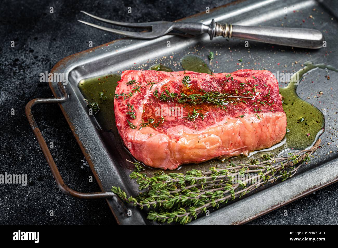 Marinated Raw striploin, New york steak with olive oil, thyme and