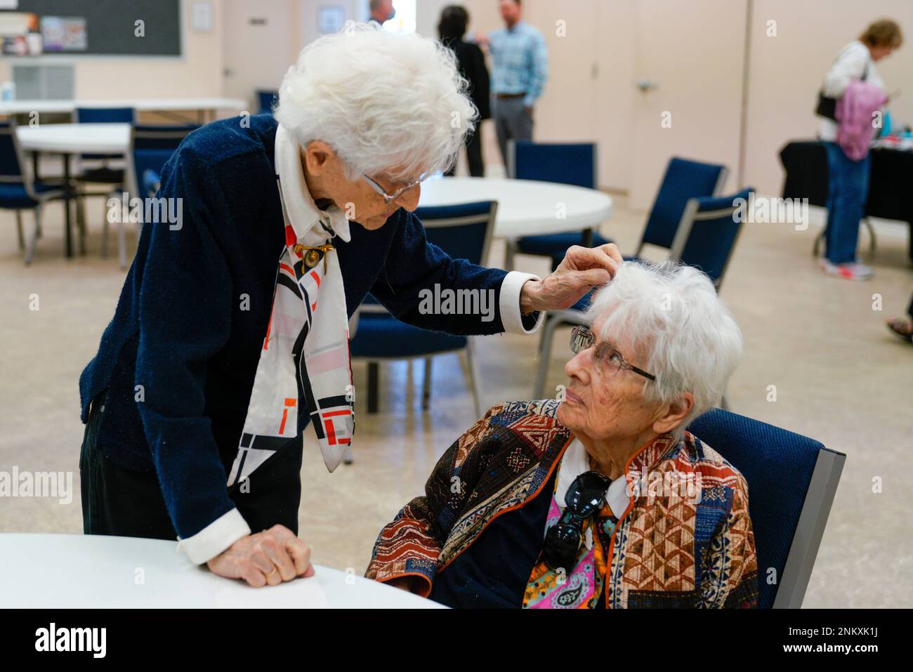 Norma Matthews,l eft, fixes Edith Antoncecchi's hair as they attend the ...