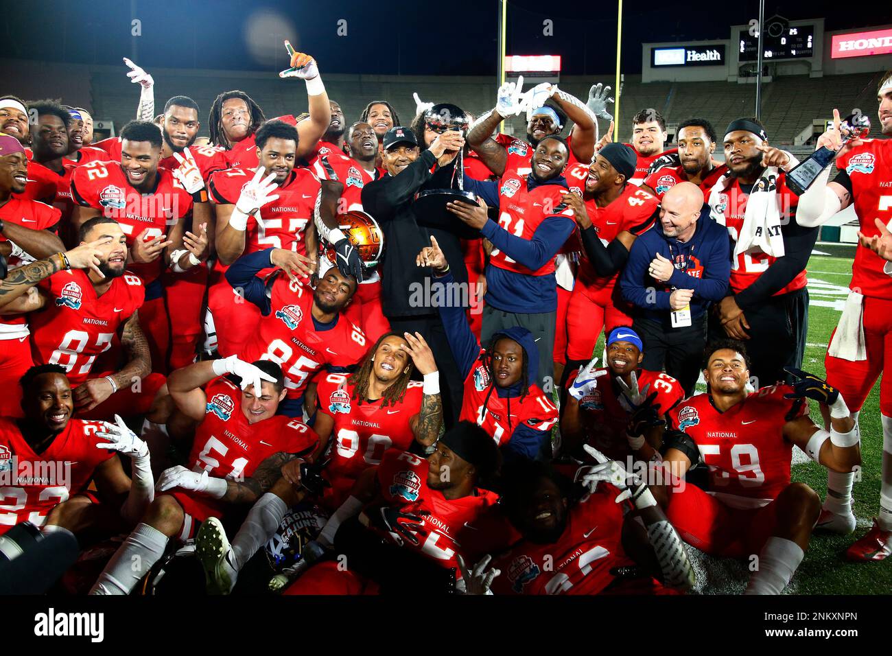 National Team coach Marvin Lewis celebrates with his players after