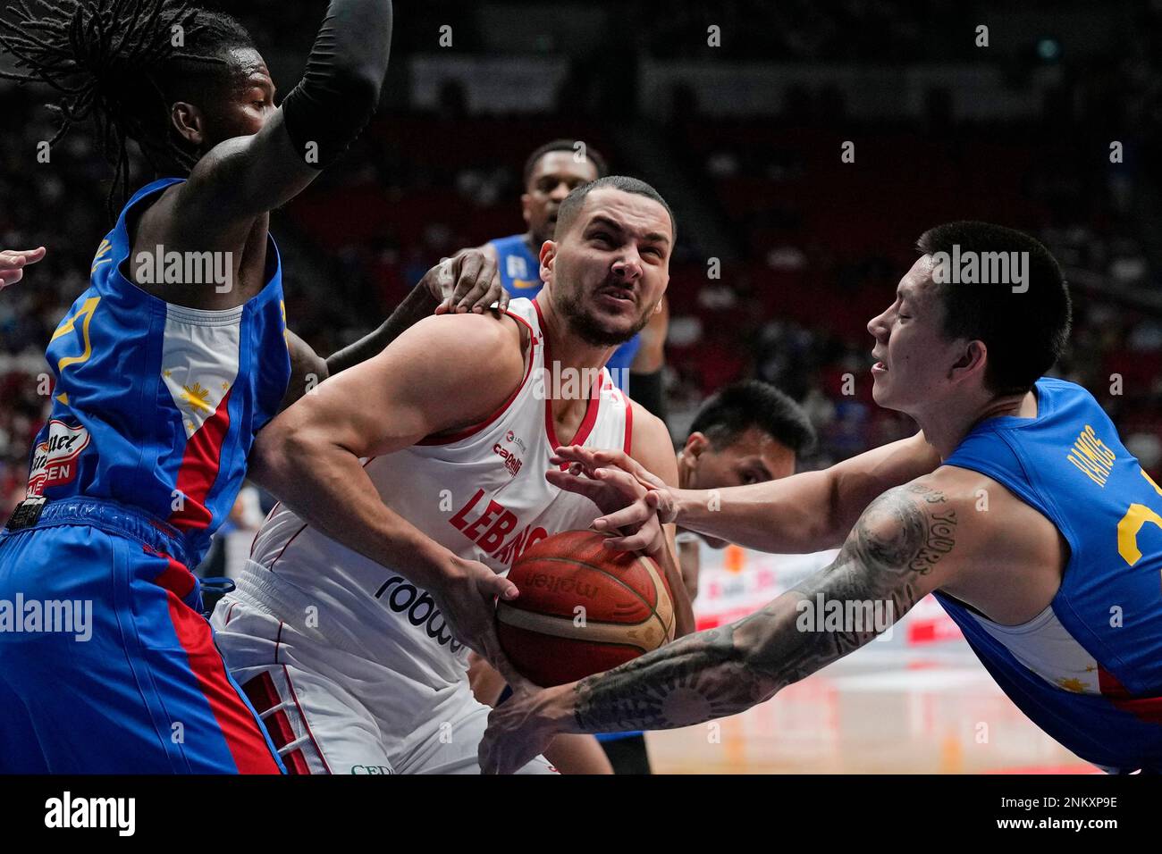 Lebanon's Naim Rabay, center, battles for ball possession against ...