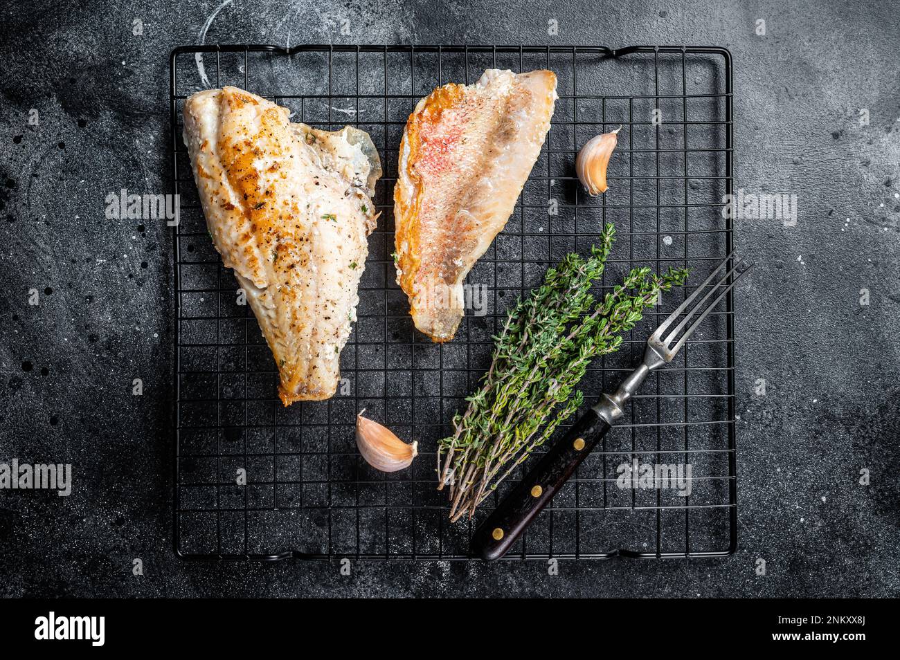 Grilled sea red perch fillet, Snapper fish on a rack. Black background ...