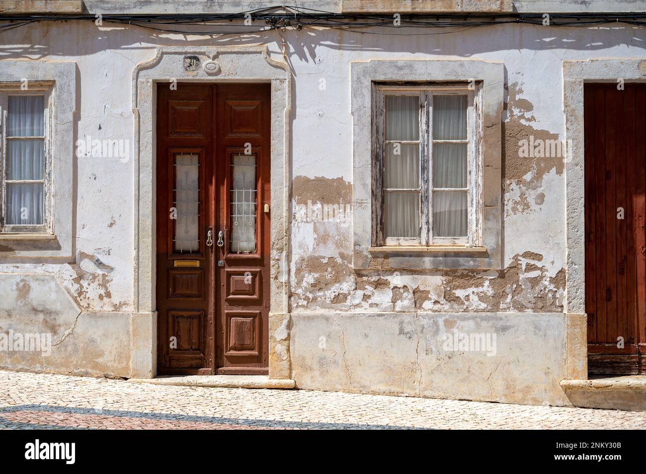 An old painted door in a old buildling in Lagos Algarve Portugal showing the traditional architecture. Stock Photo