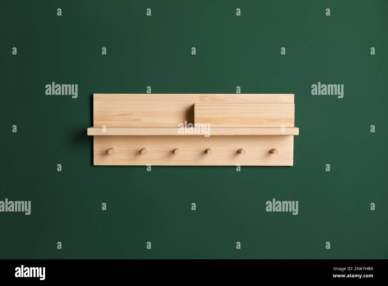 Wooden hanger for keys on green wall Stock Photo Alamy