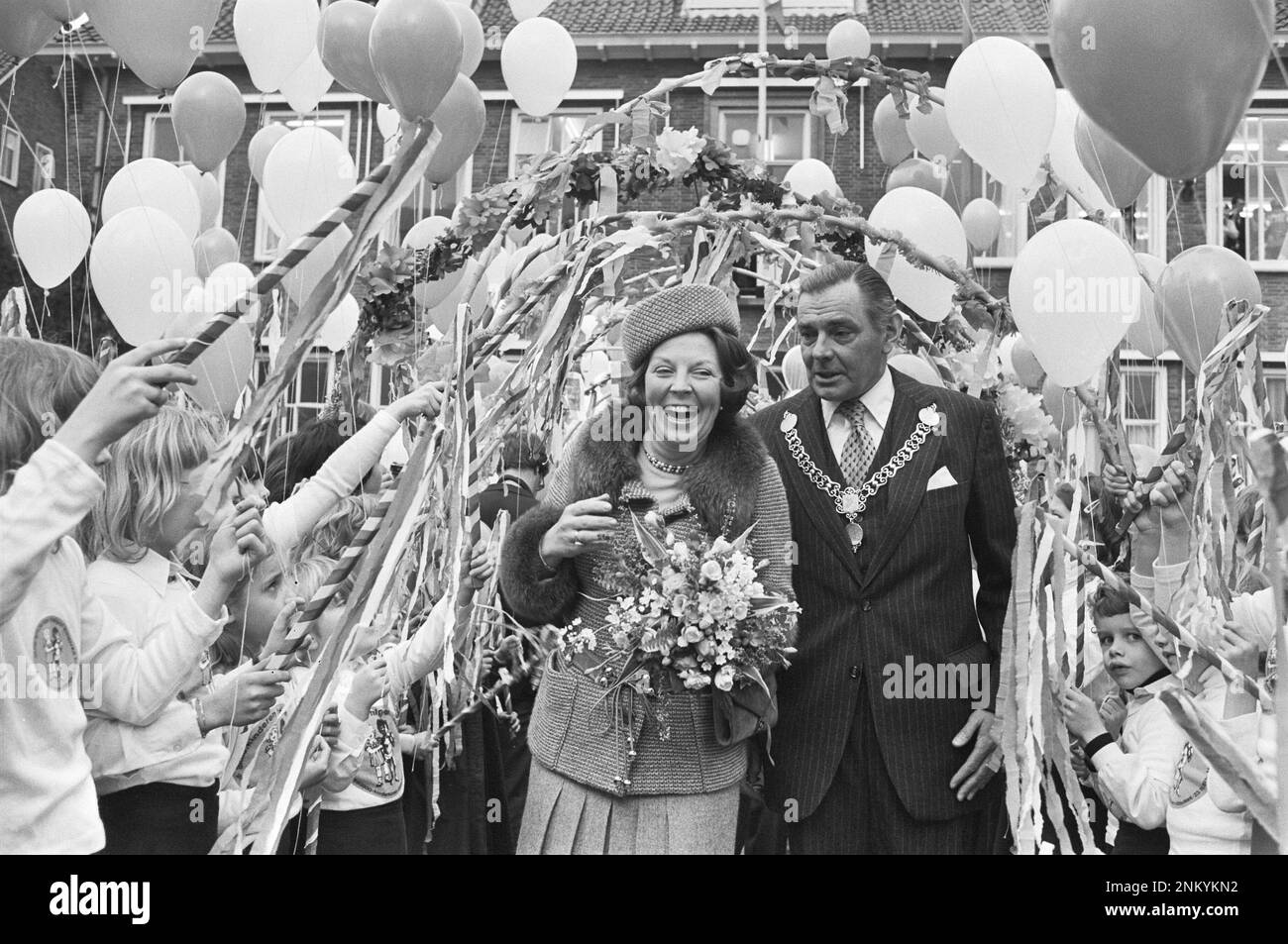 Netherlands History: Princess Beatrix opens new town hall of Ridderkerk; Princess Beatrix walks with Mayor Verplanke through a hedge formed by children ca. March 11, 1980 Stock Photo