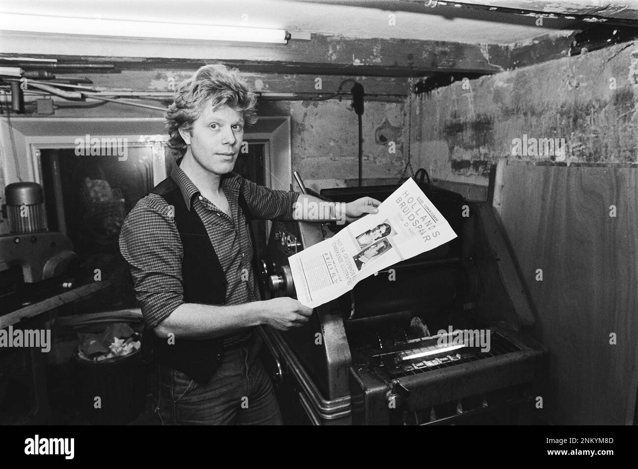 Netherlands History: Rob Stolk (formerly Provo, now printer). In his hand a pamphlet that he printed as Provo under the name anti-advertising agency Sneek ca. February 12, 1980 Stock Photo