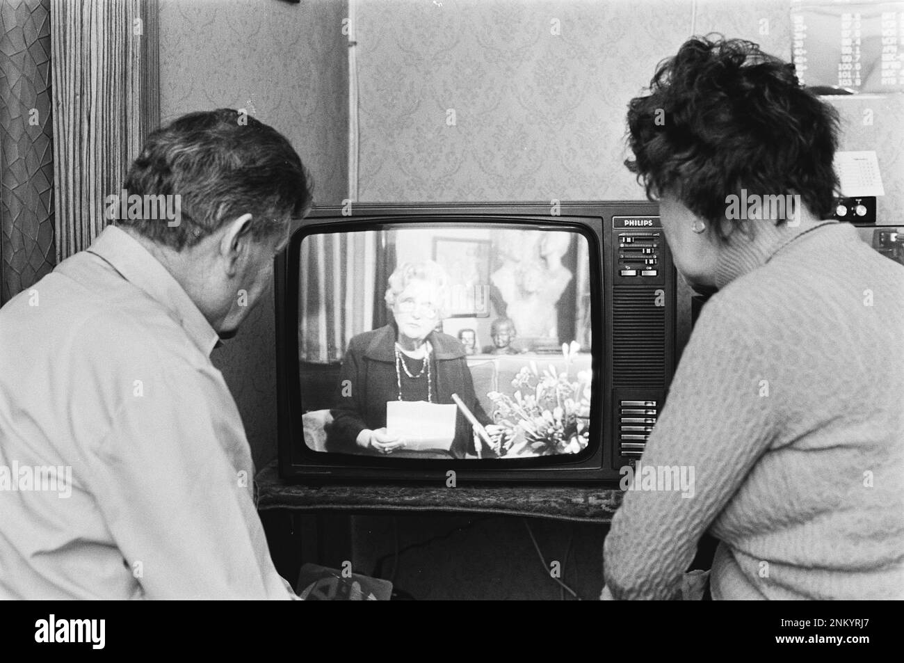 Netherlands History: Netherlands residents watch as Queen Juliana announces her abdication via TV; Prime Minister Dries van Agt during a speech on TV ca. February 1, 1980 Stock Photo