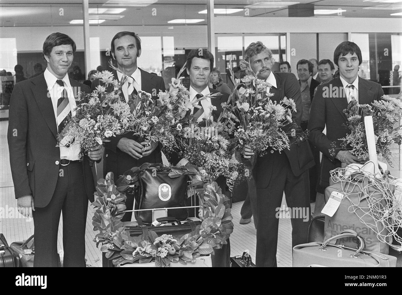 Original Caption: Part water polo team back from Montreal, from left to right: Ton Buunk, trainer Trumbic, Hans Smits and reserve keeper Alex Boegschoten in de Bloemen ca. 30 July 1976 Stock Photo