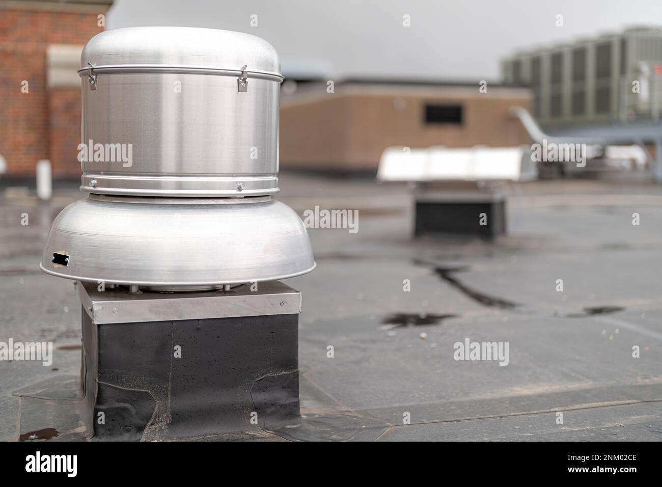 Photo of a roof exhaust ventilation fan on a new EPDM on a large