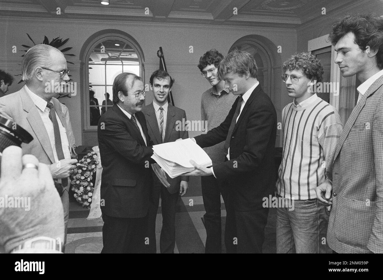 Students offer signatures against Star Wars (U.S. nuclear shield) to chairman of the parliamentary committee Relus ter Beek ca. 1985 Stock Photo