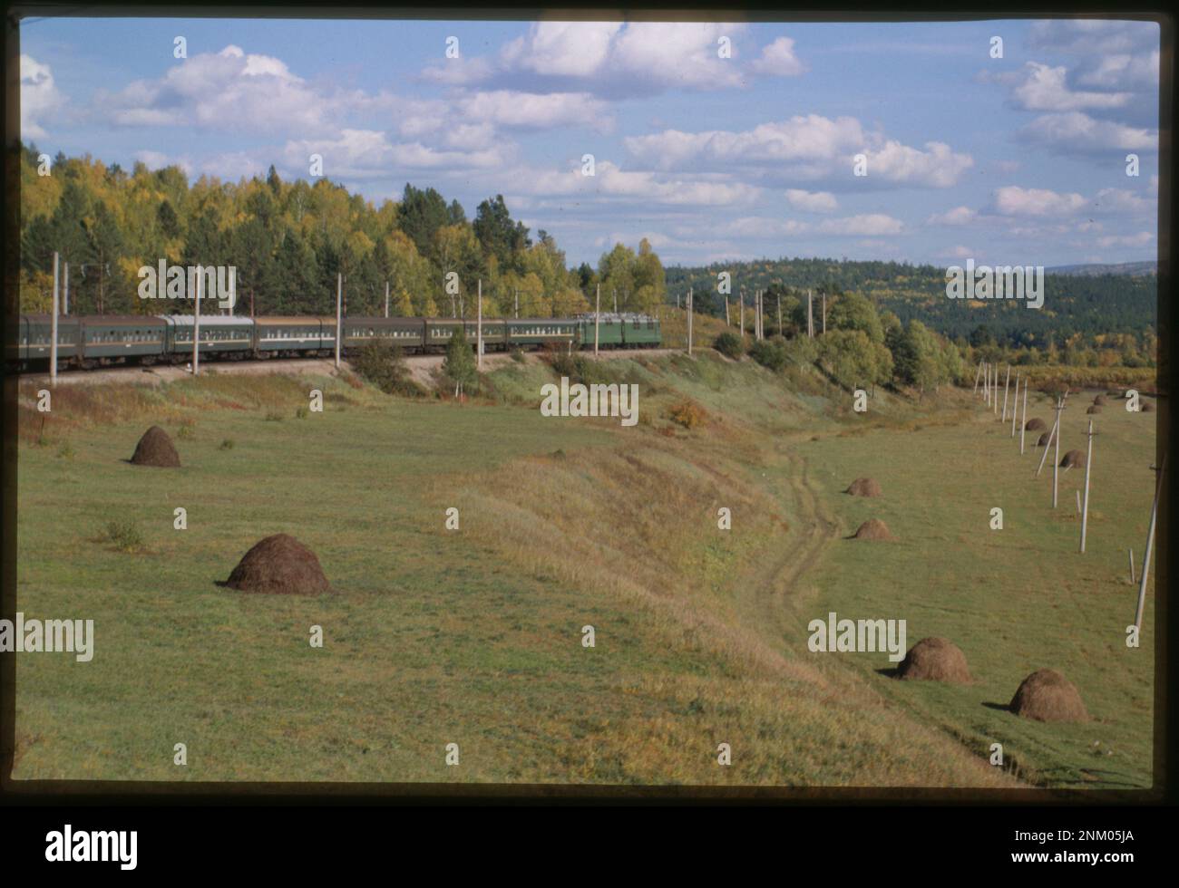 A Trans-Siberian train travels east along the Khilok River valley near ...