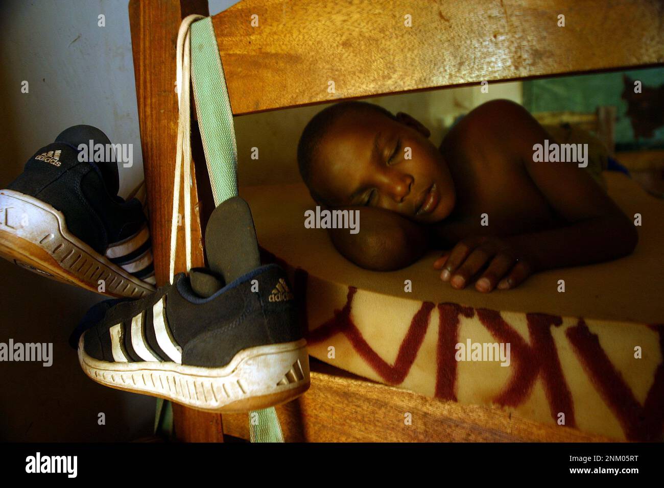 A STREET CHILD SLEEPING ON A BUNK BED AT A CENTRE FOR STREET CHILDREN