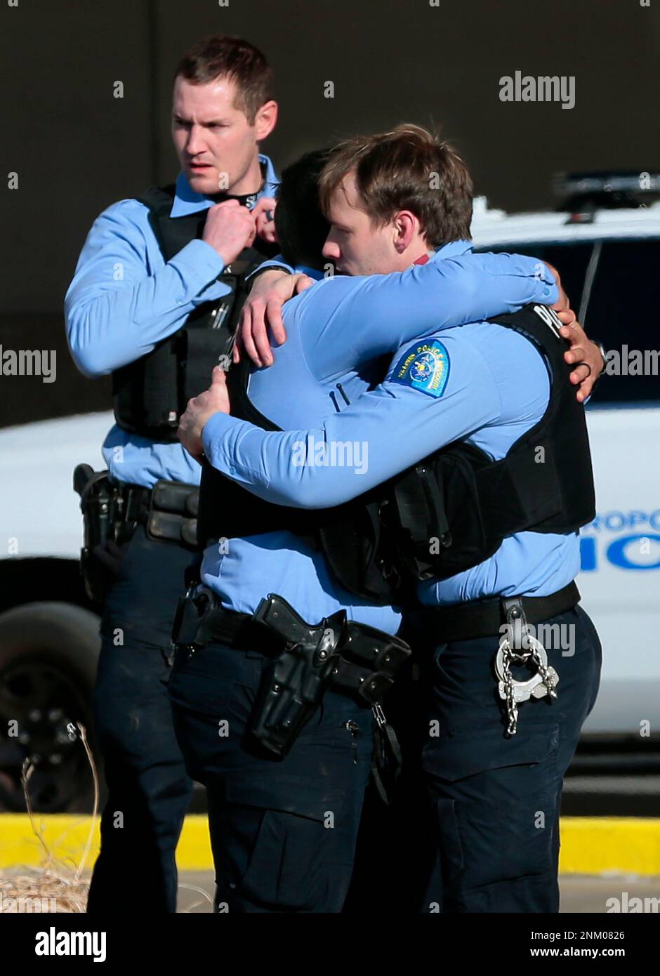St. Louis police officers embrace outside the emergency room of Barnes ...