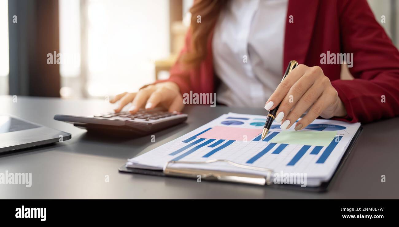 Accountant woman working with calculator and laptop computer, Tax