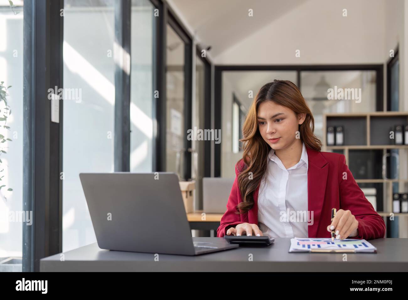 Accountant woman working with calculator and laptop computer, Tax