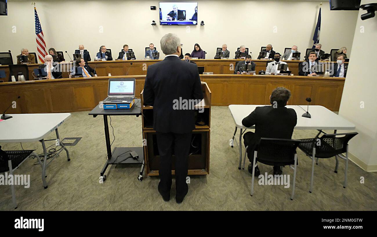 Virginia Secretary of Finance Stephen E. Cummings, center, faces the ...