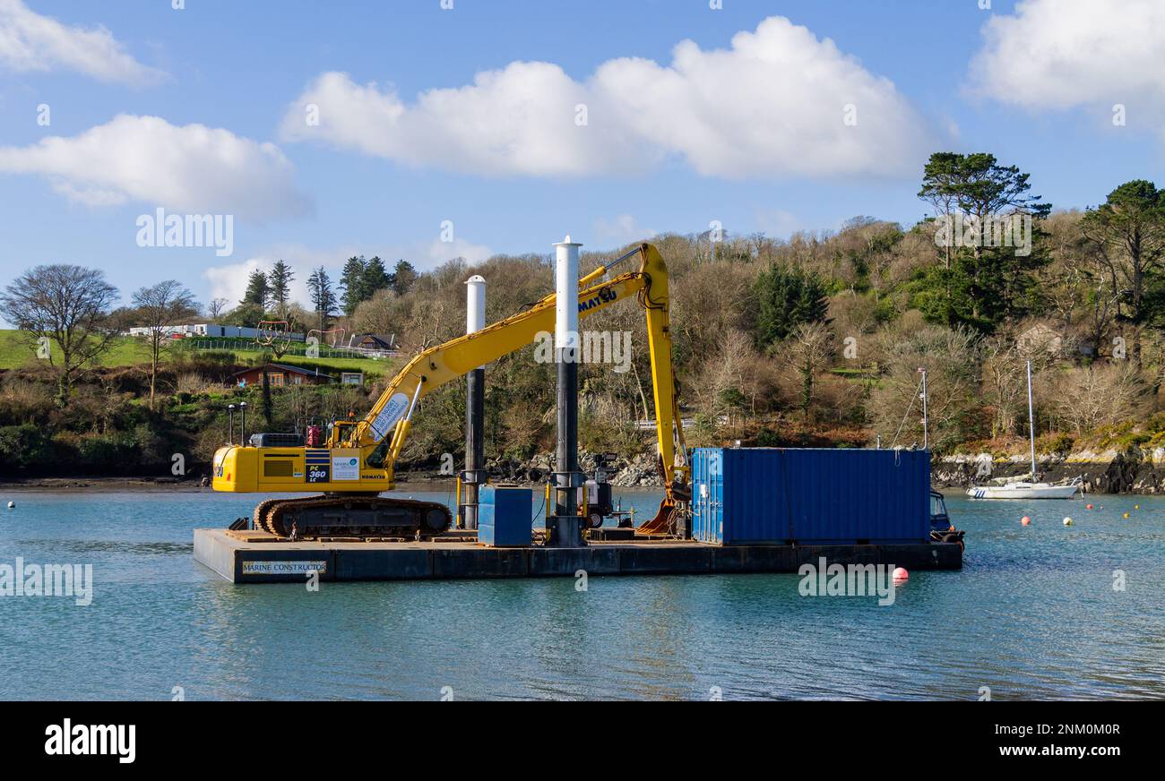 Mechanical Excavator on floating pontoon. Stock Photo