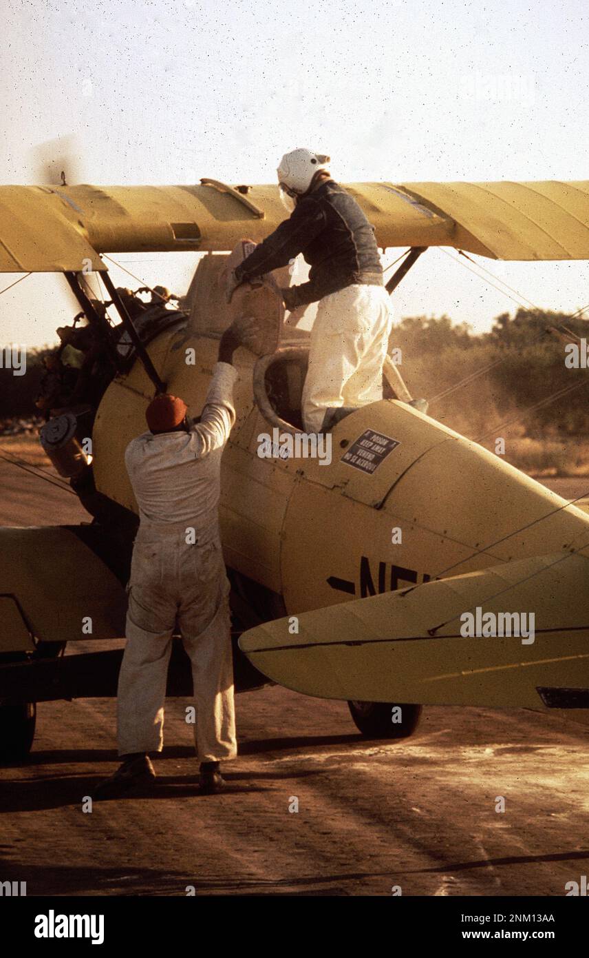 1970s United States A cropduster pilot is preparing to sulfurdust