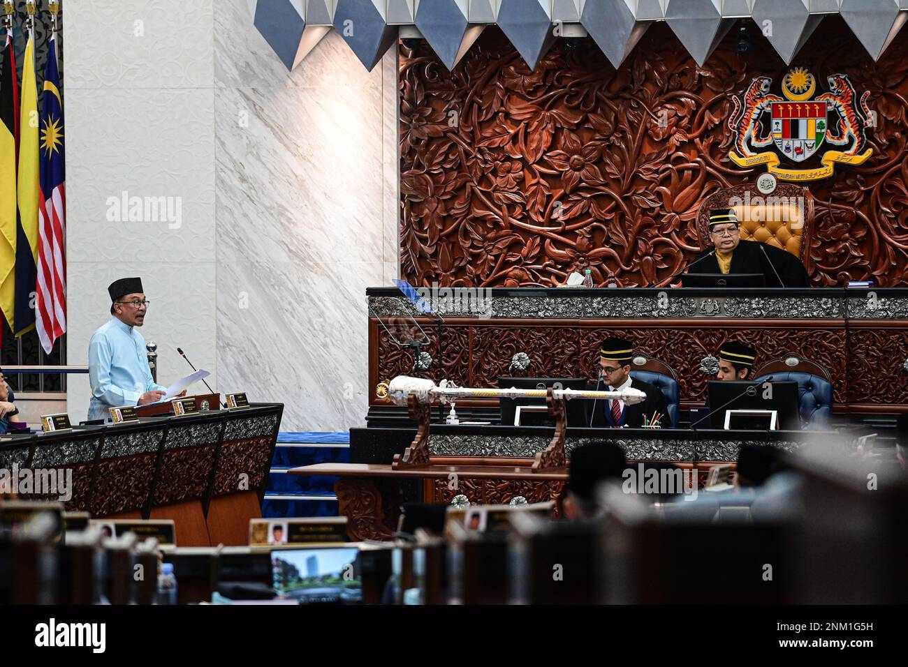 (230224) -- KUALA LUMPUR, Feb. 24, 2023 (Xinhua) -- Malaysian Prime Minister Anwar Ibrahim (L, stand) proposes the national budget at the parliament house in Kuala Lumpur, Malaysia, Feb. 24, 2023. The Malaysian government led by Prime Minister Anwar Ibrahim on Friday proposed a 388.1 billion ringgit (87.5 billion U.S. dollars) national budget aimed at helping the country resolve a number of domestic issues. Anwar, who is also the finance minister, said the budget will focus on addressing the high cost of living, further strengthening the social safety net and enhancing the micro, small and m Stock Photo