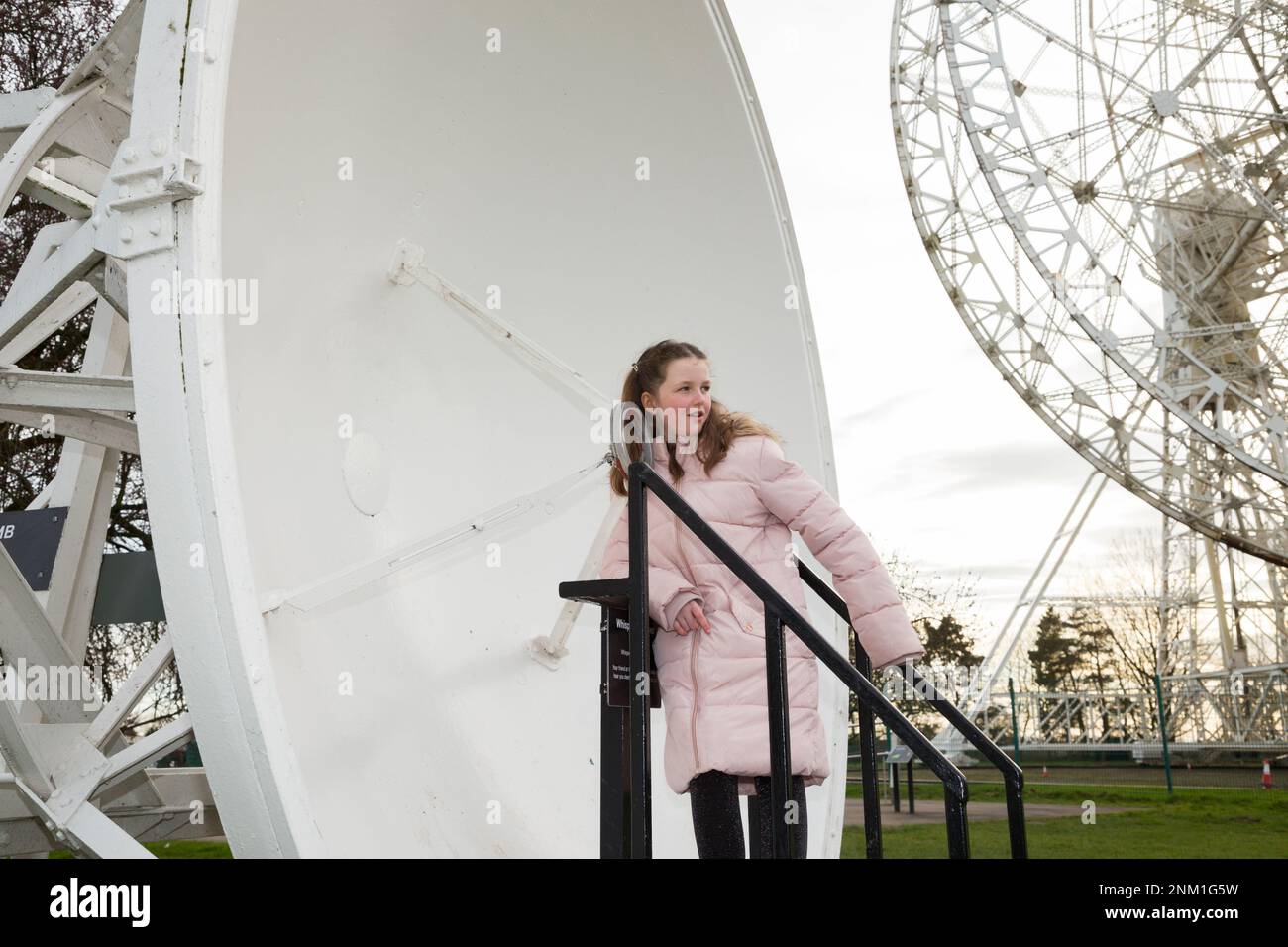 Kids / girls / children / child listen and speak at the Whispering Dish / Dishes which act as an acoustic mirror to transmit and focus sound waves. (133) Stock Photo