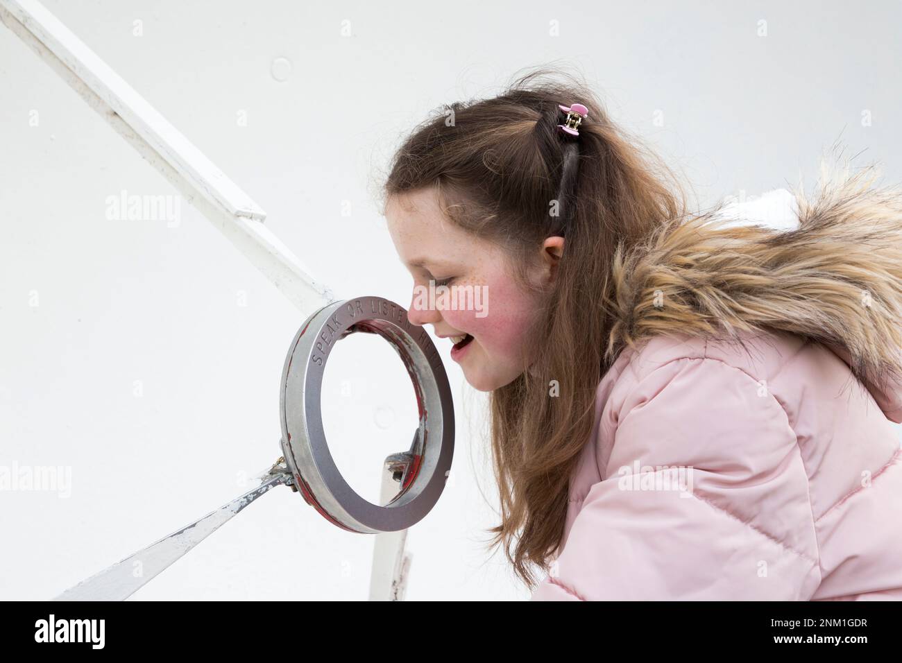 Kids / girls / children / child listen and speak at the Whispering Dish / Dishes which act as an acoustic mirror to transmit and focus sound waves. (133) Stock Photo