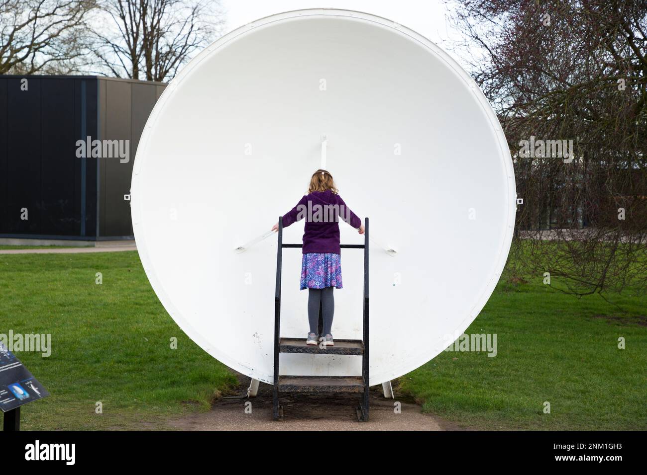 Kids / girls / children / child listen and speak at the Whispering Dish / Dishes which act as an acoustic mirror to transmit and focus sound waves. (133) Stock Photo