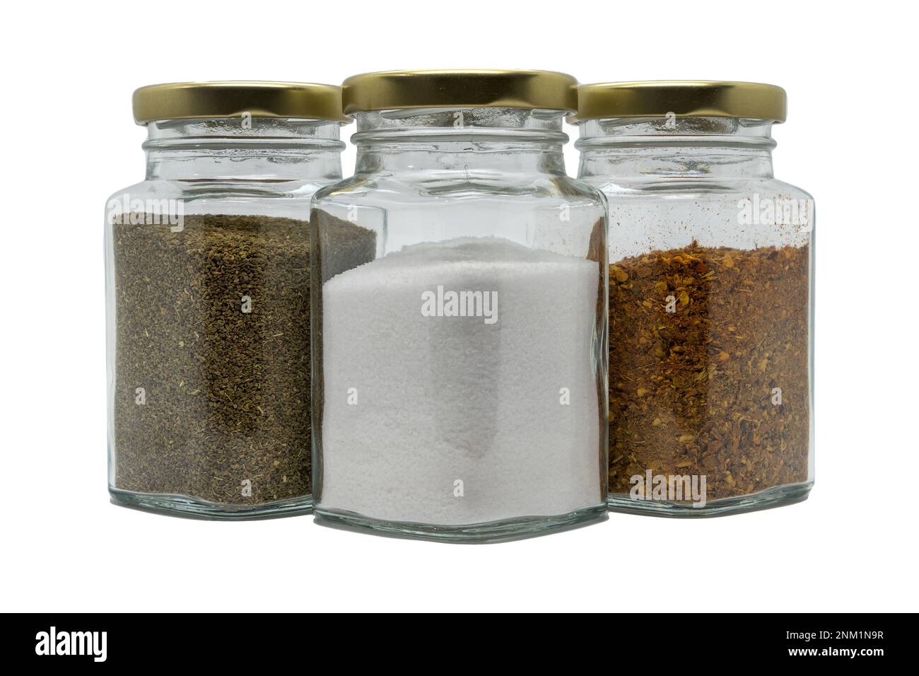 Three glass jars with spices. Salt, celery seeds and chili powder