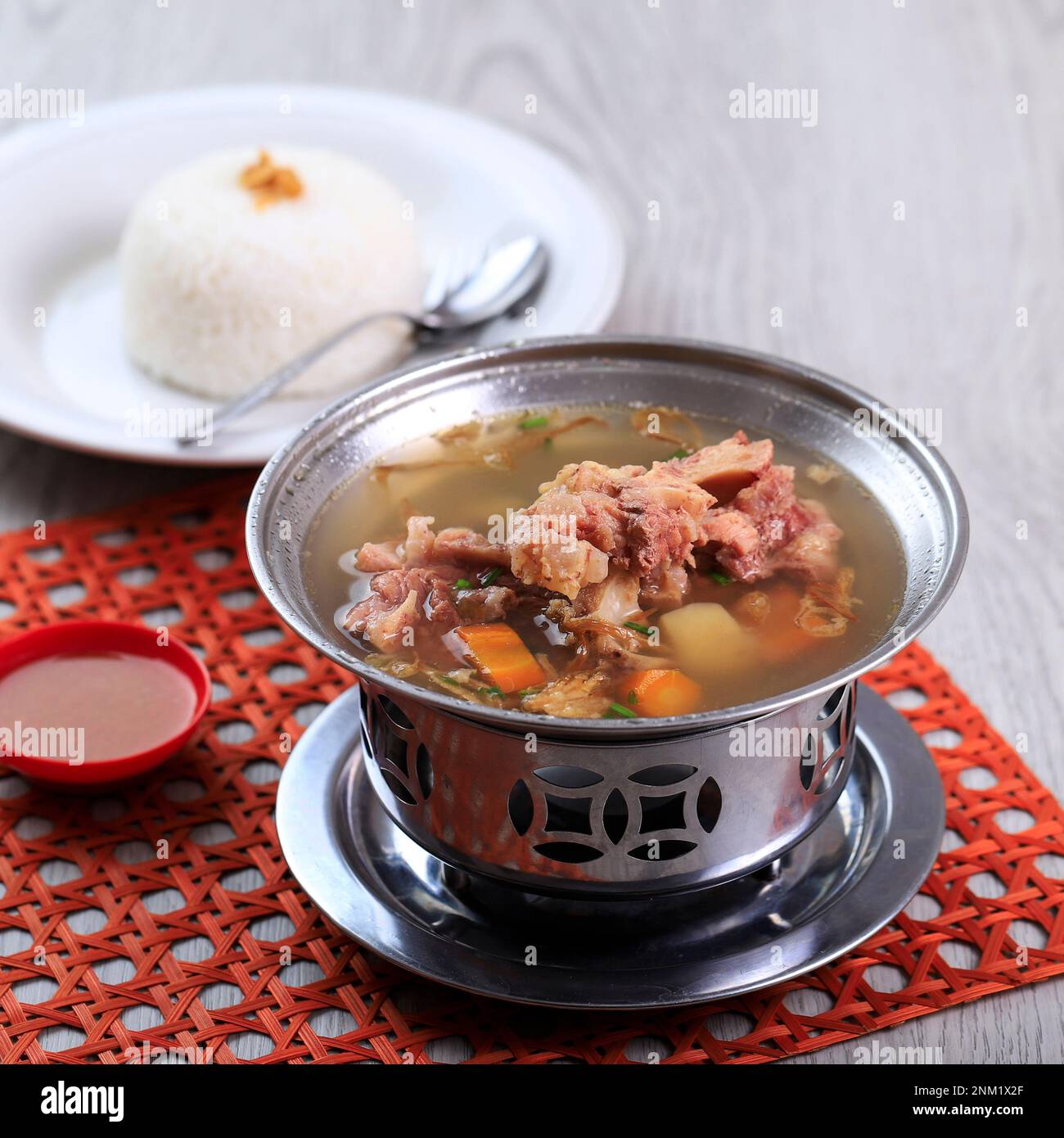 Sop Buntut Oxtail Soup with Potato and Carrot Served with White Rice, on the Table Stock Photo